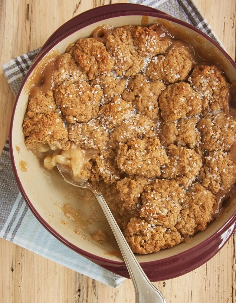 Autumn spiced pear cobbler topped with a golden crust and fresh pears